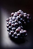 Red grapes on a dark surface