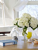 A vase of white hydrangeas on a table