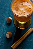 Carrot juice with apple, cinnamon and hazelnuts
