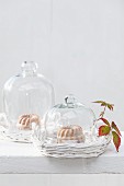 Mini iced Bundt cakes under glass cloches