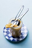 A jar of dulce de leche with spoons