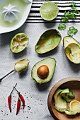 Cut avocadoes, limes, chilli peppers ready for guacamole.