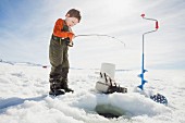 A little boy ice fishing