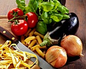 pasta melanzane ingredients with eggplant (aubergine), onions, basil tomatoes