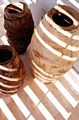 Pattern of light and shadow on primitive ceramic vases