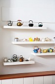 Collections of teapots on floating shelves
