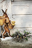 Wooden cut-out-style Easter bunny ornament and arrangement of herbs and spices