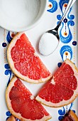 Pink grapefruit slices with sugar