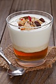 Natural yogurt on honey topped with fruit muesli in a glass