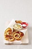 Fried onion rings in beer batter with a dip