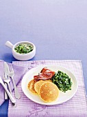 Polenta pancakes with bacon and a chard medley