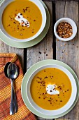 Cream of pumpkin soup garnished with chilli and sour cream