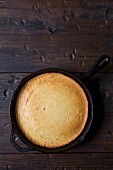Slice of Corn Bread Cooked in a Cast Iron Skillet