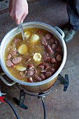 A hearty meat soup made with sweetcorn and sausages