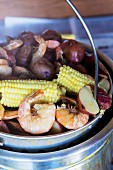 Stew made with sweetcorn, potatoes, sausages and prawns