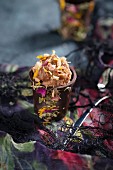 A chocolate cup filled with nougat cream and dried flower petals