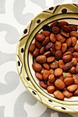 A bowl of carob bean seeds