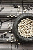 White peppercorns in a mortar