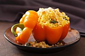 A stuffed yellow pepper filled with couscous