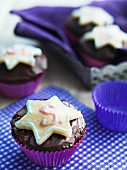 Chocolate cupcakes decorated with star-shaped biscuits