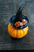 An ornamental pumpkin with a witches hat
