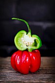 Red and green Scotch Bonnet chilli peppers, whole and halved