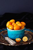 Kumquats in blue ceramic bowl