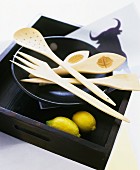 Decorative hand-carved cutlery made from orange wood