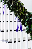 Garland of leaves with satin ribbons decorating banister rail