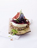 A slice of bread topped with brie, onion chutney and figs