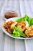 Eggs with onion sauce on a bed of salad