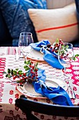 Set table with twigs of berries decorating napkins