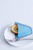 Slice of bread in hand-sewn decorative pocket in checked fabric