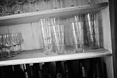 Glasses stacked in a wooden shelf