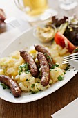 Sausages on a bed of potato salad