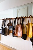 Vintage handbags hanging on coat rack