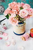 Bouquet of pink roses in nostalgic tin can