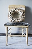 Decorative wreath on old chair with fur seat cushions