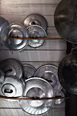 Arrangement of shiny pot lids and rusty pots
