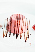 Strawberry panna cotta decorated with chocolate sauce