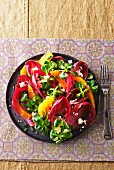 A mixed leaf salad with oranges