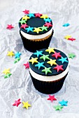 Two lemon cupcakes decorated with stars