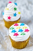 Cupcakes topped with vanilla cream and decorated with stars