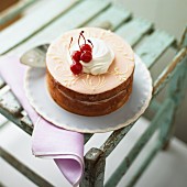 A marzipan cake with maraschino cherries and cream