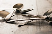 Old silver spoons on a wooden table