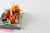 Pimms with strawberries and oranges on a tray