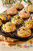 Muffins decorated with colourful chocolate beans for a children's birthday party