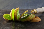 A sliced kiwi and a knife