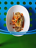 Cod fillet with ginger and carrot sauce on a bed of couscous