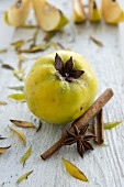 A quince, cinnamon sticks and star anise